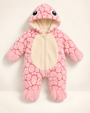 Baby zipped inside AquaCuddle plush wearable turtle shell onesie laughing on nursery rug